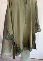 Olive green dress with floral embroidery on a white background