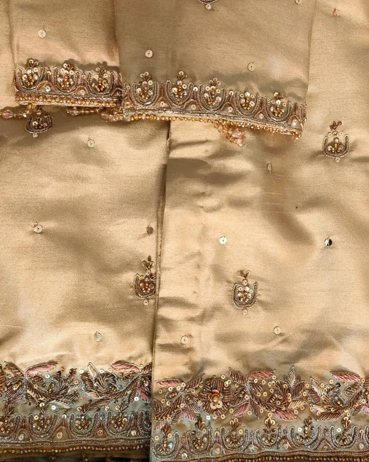 Beige fabric with intricate gold embroidery