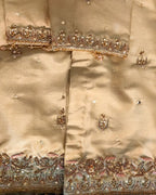 Beige fabric with intricate gold embroidery