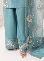 Teal traditional outfit with floral embroidery on pants and dupatta against a neutral background