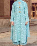 Light blue embroidered traditional outfit with gold details against a blurred architectural background